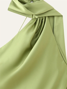 Detail of light green satin halter neck dress showing smooth fabric texture and neat stitching