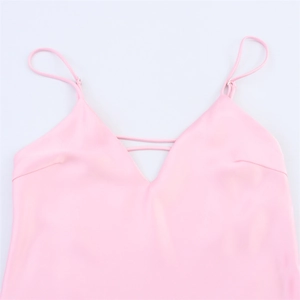 Detail of pink satin camisole featuring deep V-neck and adjustable thin straps