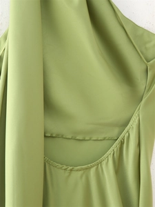 Detailed close-up of fruit green cutout back design with fine stitching and pleats