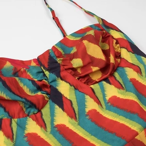 Detailed close-up of vibrant zigzag pattern on colorful summer dress with adjustable straps