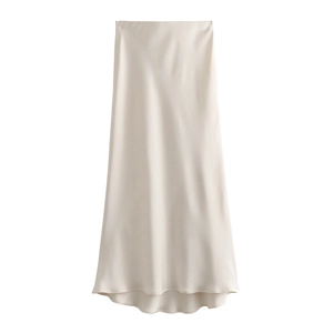 Detail of champagne satin midi skirt showing smooth texture and pearlescent sheen