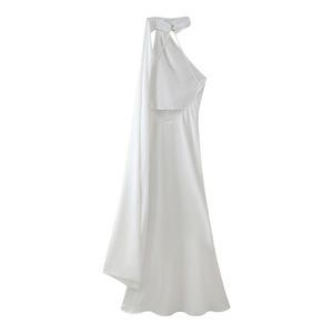 Detail of white halter neck dress with deep V-back, satin shine, and golden button accent