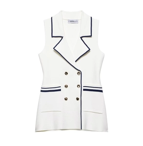 Detail of ivory knit vest with navy blue trim and gold double-breasted buttons