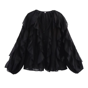 Detail view of black chiffon V-neck shirt featuring ruffled layers and button closure