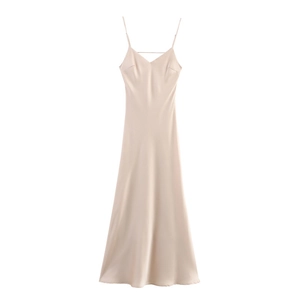 Detail of champagne satin slip dress showing V-neckline and fine shoulder straps