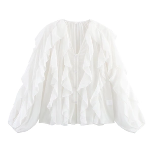 Detailed view of white chiffon blouse featuring layered ruffles and V-neckline texture