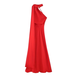 Detail of red satin dress with halter neck, white buttons, and long draping shoulder sash