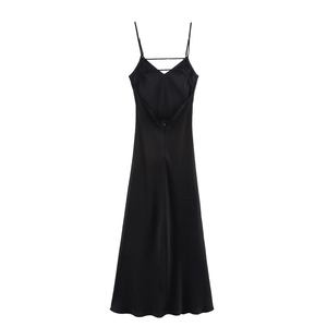 Detail of black satin maxi dress featuring an elegant backless criss-cross strap design