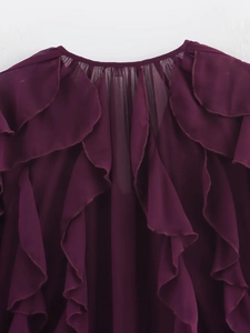 Detail of layered ruffles and sheer wine red pleated fabric on elegant women blouse