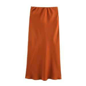 Detailed view of glossy orange satin high-waist midi skirt fabric texture and drape