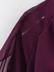 Close-up of purple pleated chiffon fabric showing detailed texture and stitching
