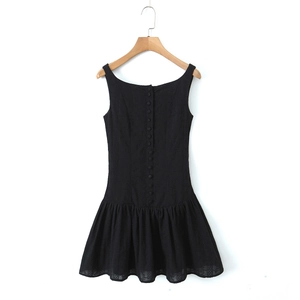 Detail of a chic black backless drop-waist mini dress with a row of buttons and square neck