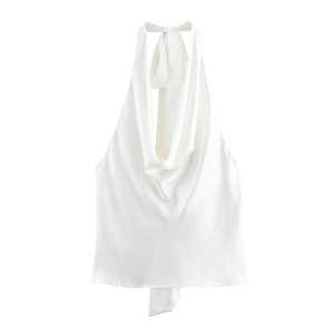 Detail of white satin halter top featuring a draped cowl neck and silky glossy fabric texture