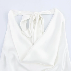 Detailed close-up of white satin halter top featuring cowl neck and back neck tie detail