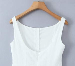 Close-up of white summer mini dress featuring refined jacquard texture and hidden back zipper
