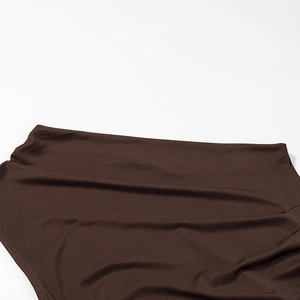 Détail du tissu en satin marron chocolat et des coutures de la taille de la robe