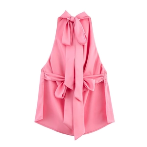 Detailed view of pink satin halter top featuring decorative neck and waist ribbon bows