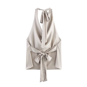 Detail of silk satin halter top featuring an elegant back bow tie and glossy fabric texture