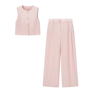Close-up of pink two-piece set featuring buttoned vest top and high-waist wide-leg pants