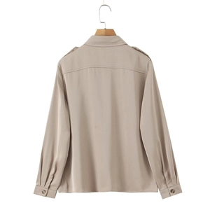 Detail view of khaki satin shirt back with shoulder straps and glossy fabric texture