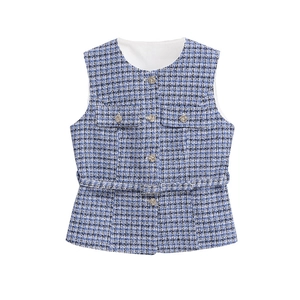 Detailed close-up of blue tweed vest with metal buttons and matching waist belt