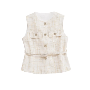 Detail of tweed vest with gold thread weaving, metal embossed buttons, and matching belt