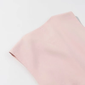 Close-up of pink fabric texture with fine horizontal ribbed details and clean seam stitching