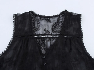 Detail of V-neckline on black lace shirt featuring paisley embroidery and delicate buttons
