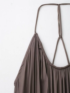 Detail of coffee brown halter neck dress showing pleated neckline and silky fabric texture