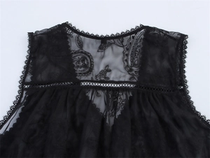 Close-up of intricate floral embroidery and lace mesh details on a black sleeveless top