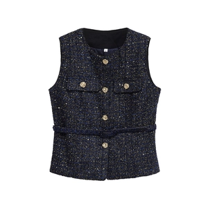 Detail of navy tweed vest with gold embossed buttons and woven metallic textures
