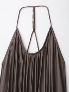 Detail of coffee brown pleated camisole dress featuring thin straps and neck tie