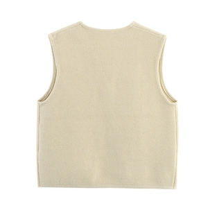 Detail view of the back of a beige sleeveless knitted vest with fine texture and crew neck