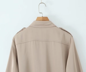 Detail view showing the back of the khaki satin shirt with epaulettes and yoke stitching