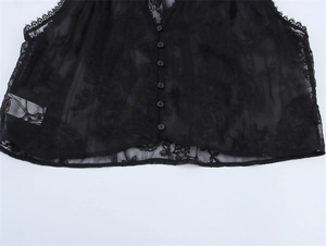 Close-up of black floral lace sleeveless top with delicate buttons and scalloped hemline