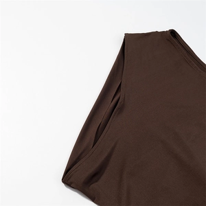 Detail of dark brown sleeveless dress showing smooth knit fabric and clean stitching