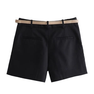 Close-up of black tailored shorts with belt and back welt pockets on white background
