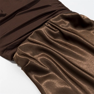Detail of coffee dress featuring matte knit fabric joined with glossy pleated satin
