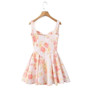 Detailed view of pink floral mini dress featuring wide straps and vibrant flower patterns