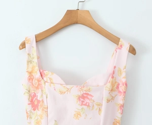 Detail of square neckline and floral print on light pink sleeveless summer dress