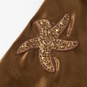 Detailed macro view of bronze satin fabric with sequined starfish embroidery decoration