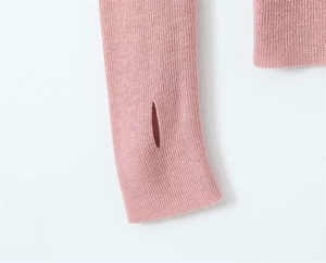 Close-up of pink knit sleeve showing functional thumb hole design and fine texture