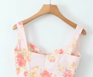 Detail of pink floral dress featuring sweetheart neckline and invisible back zipper