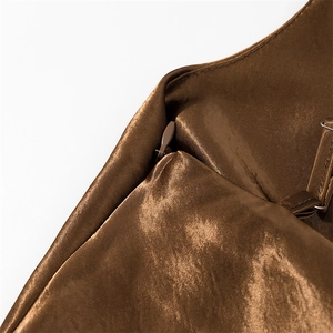 Macro shot of dark brown satin dress with invisible zipper and adjustable shoulder strap