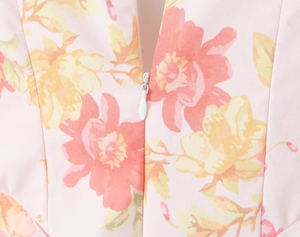 Detailed macro view of the invisible zipper closure on the floral print dress