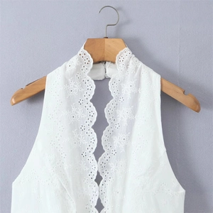 White sleeveless lace top with floral eyelet embroidery and a scalloped halter neckline