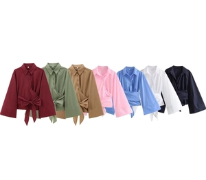 Detail shot of long-sleeve poplin shirts in seven colors with bow-tie waist and flare cuffs
