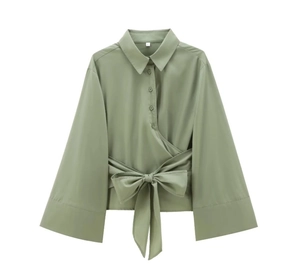 Detail of green poplin shirt featuring a waist bow tie and flared cuffs with size S label