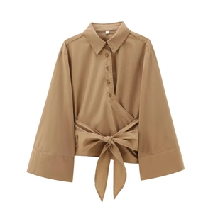 Detail of khaki poplin shirt featuring a waist bow tie and pleated button placket