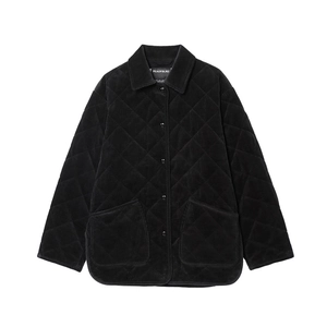 Detail shot of black corduroy quilted jacket featuring diamond stitching and large pockets
